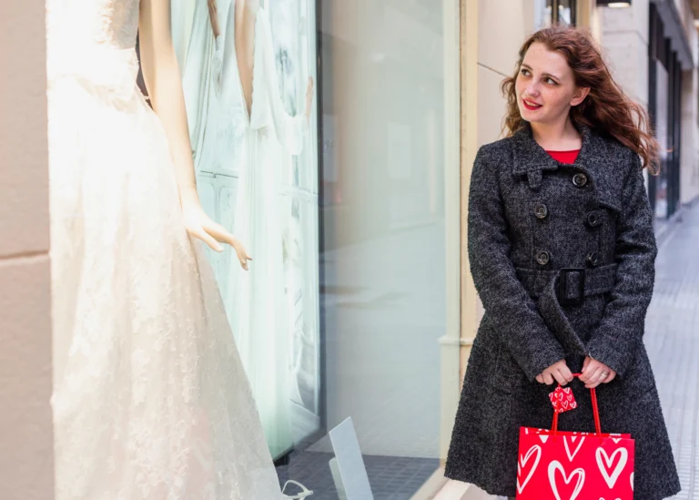 woman-looking-wedding-dress-shop-window